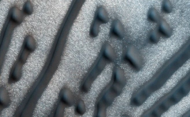 Марсианские дюны Морзе. Марсоходы и зонды уже довольно долго изучают пески Марса, но недавние фотографии вызвали у исследователей некоторое замешательство. В феврале 2016 станция сделала фото региона с дюнами, напоминающими точки и тире азбуки Морзе. Если «тире» несложно объяснить сильным ветром, происхождение «точек» до сих пор остаётся неизвестным.